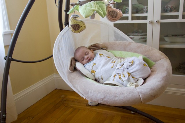 baby boy sam swings in a Fisher Price My Little Snugabunny Cradle 'n Swing