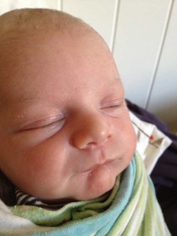 Close-up of baby boy Sam looking smug.