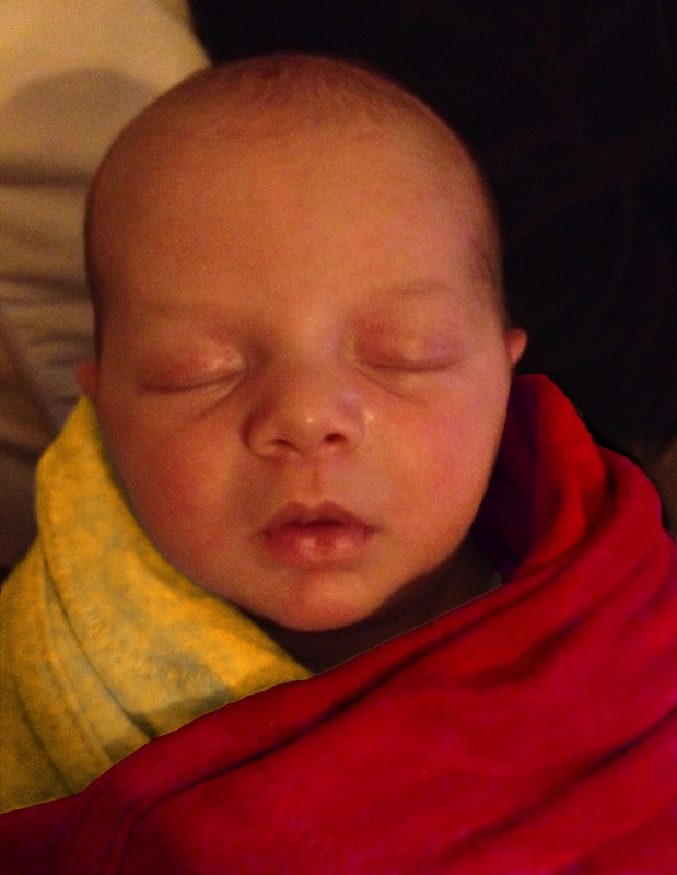 bald baby Sam, swaddled and photoshopped to look like the Dalai Lama in a saffron robe.