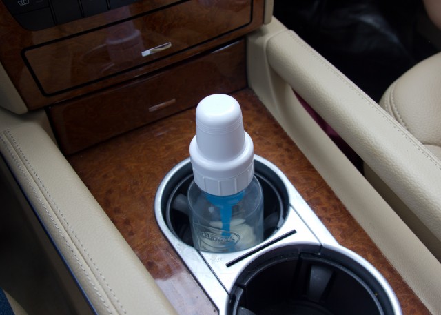 a baby bottle in the cup-holder of our car