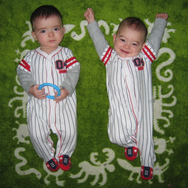 Twin baby boys of summer, Max and Sam, don pinstripes.